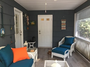 Relaxing screened porch has comfortable seating before & after your beach day