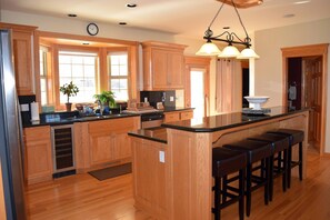 Large kitchen with all wood floors and granite counter tops with breakfast bar