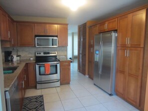 Fully furnished kitchen with utensils & cookware including grilling supplies