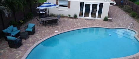 Large Pool  Sofa Two Chairs Dining Table Weber Grill, Main House In Background