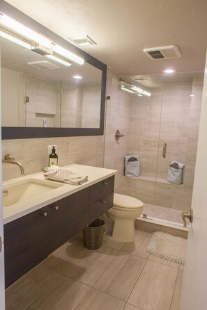 Floating vanity and large spa shower w/ integrated shower seating.