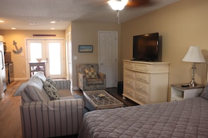 Living room with foldout sofa, chair and 42' TV. 