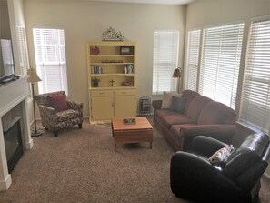 recliner, Lazy Boy sofa, guide books, DVDs, cards and games in yellow hutch