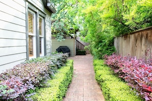 The lush path and the back patios are well lit at night.