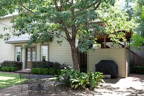 The entrance to yourstairs is to the right of the building, just past the grill.