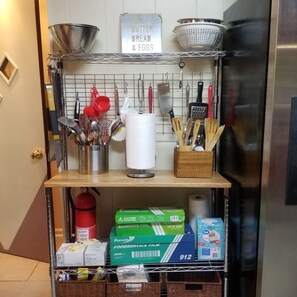 Abundance of kitchen utensils, foil & plastic wrap, garbage bags & paper towels
