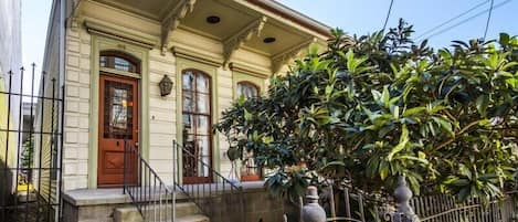 Welcome to our home! This is the formal street entrance with beautiful loquat tree and New Orleans iron work.