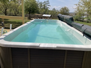 Heated pool. 8 feet by 18 feet and 3.5 feet deep. Deck to left is now complete