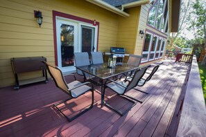 Rear deck outdoor seating, Weber grill and raised cooler.