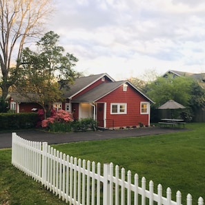 Backyard view. Paved driveway is level to the street and the main entrance.