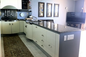 Large kitchen with built in cabinets and sub-zero refrigerator.