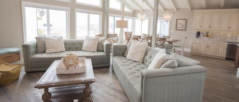Enjoy stunning beach and ocean views from the living area, a wall of windows.