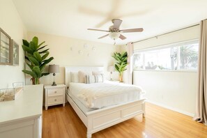 First bedroom with queen bed and blackout curtains