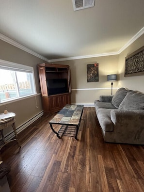 Living room with window to private patio