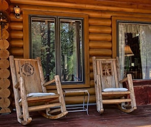 Front porch with custom hand-carved wooden rocking chairs.
