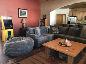 Living area to kitchen large super plush sectional & bean bags, pac man console