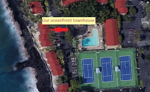 Aerial view of townhouse shoing the proximity to the ocean, pool & tennis courts
