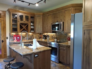 Kitchen has all stainless steel appliances with a lot of space