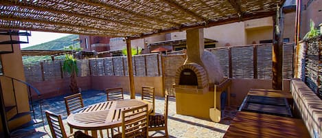 Full Outdoor Kitchen With A Wood Burning Pizza Oven