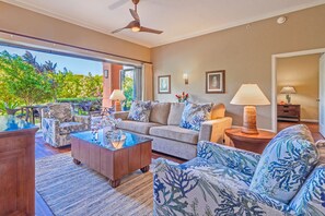 Spacious living and dining areas transition seamlessly to lush resort outside.