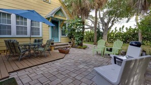 Private outdoor patio with grill and outdoor seating area and table with chairs