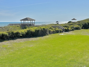 Large grassy recreation area with outdoor showers.
