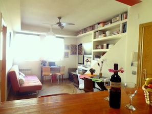 General view of living room and entrance door. Courtesy: Bottle of local wine.