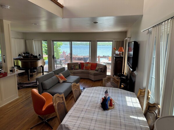 New sleeper sofa at water's edge + baby grand piano off terrace.  New furniture 