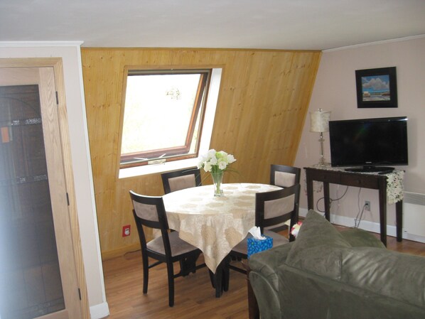 Open concept dining room with skylight and living room with wifi and cable TV