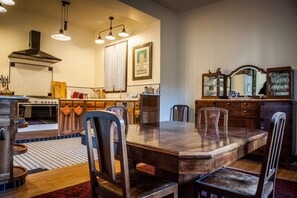 Dining room and kitchen with art deco era antiques and modern gourmet appliances
