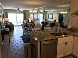 View of new dishwasher, cabinets, sink, faucet & the Ocean view from the kitchen
