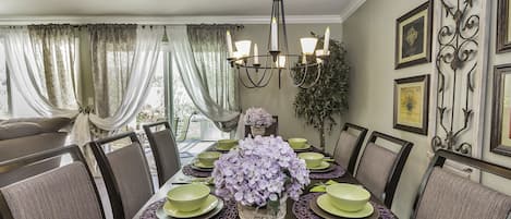 Elegant dining table for 8 under a light chandelier