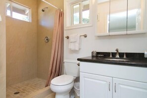 tile bathroom with shower and sitdown area.