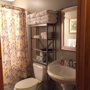Lower level bath for double- queen bedroom has tub shower.