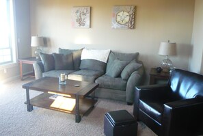 Livingroom with oversized couch and 2 leather chairs, all overlooking the ocean!