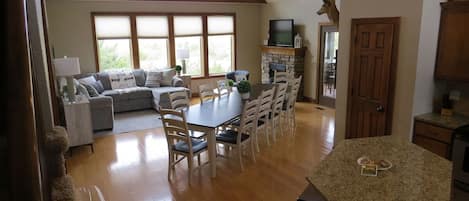 Open floor plan with large dining table and lake view