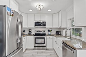 Kitchen with a fully stocked kitchen.