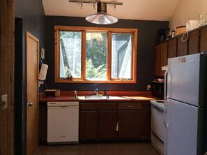 Kitchen with waffle maker, coffee pot and other useful appliances.