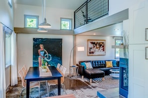 Loft Master overlooks the dining room and out onto the lawn. Original artwork.