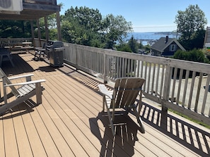 Sunny section of extra large deck overlooking the marina and breakwater