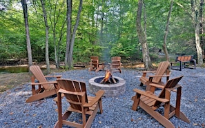 Enjoy a fire in the firepit creek side.