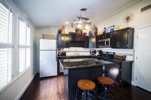 The kitchen is downstairs, with seating around the island
