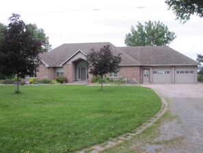 Vacation rental is on lower level lake side. View of front of house.