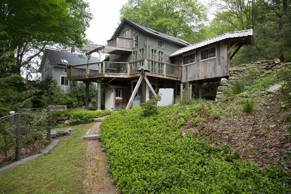 View of the home from the peaceful waterfall seating area. 