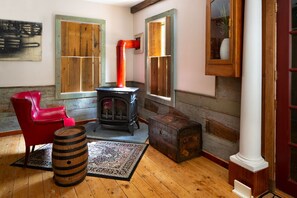 Cozy up on the main floor in two comfortable modern chairs by the gas fireplace.