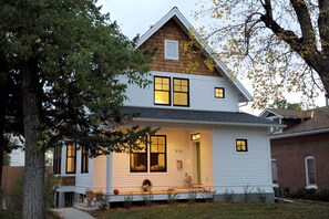 The front facade and porch where you can sit and read and greet the neighbors