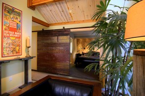 Master Bedroom in the main house with its king size bed and reclaimed barn door