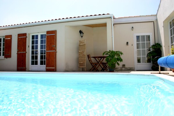 Front door of studio, right of photo, and pool