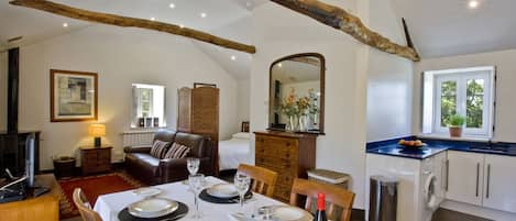 Loft style apartment 1 with vaulted ceiling, exposed beams and open plan design.