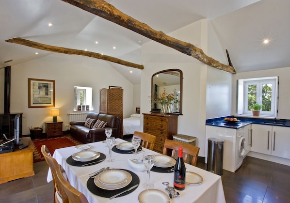 Loft style apartment 1 with vaulted ceiling, exposed beams and open plan design.